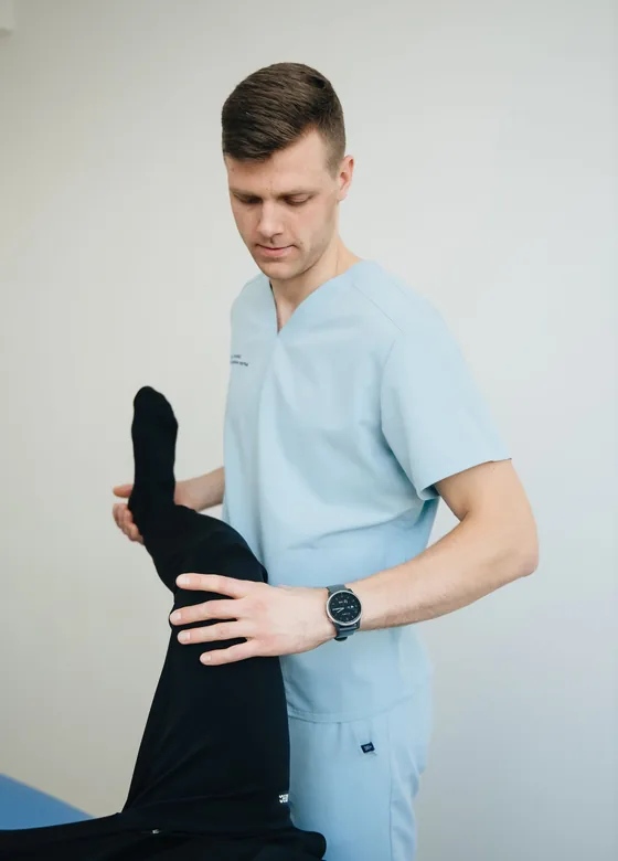 Therapist guiding a patient through an exercise